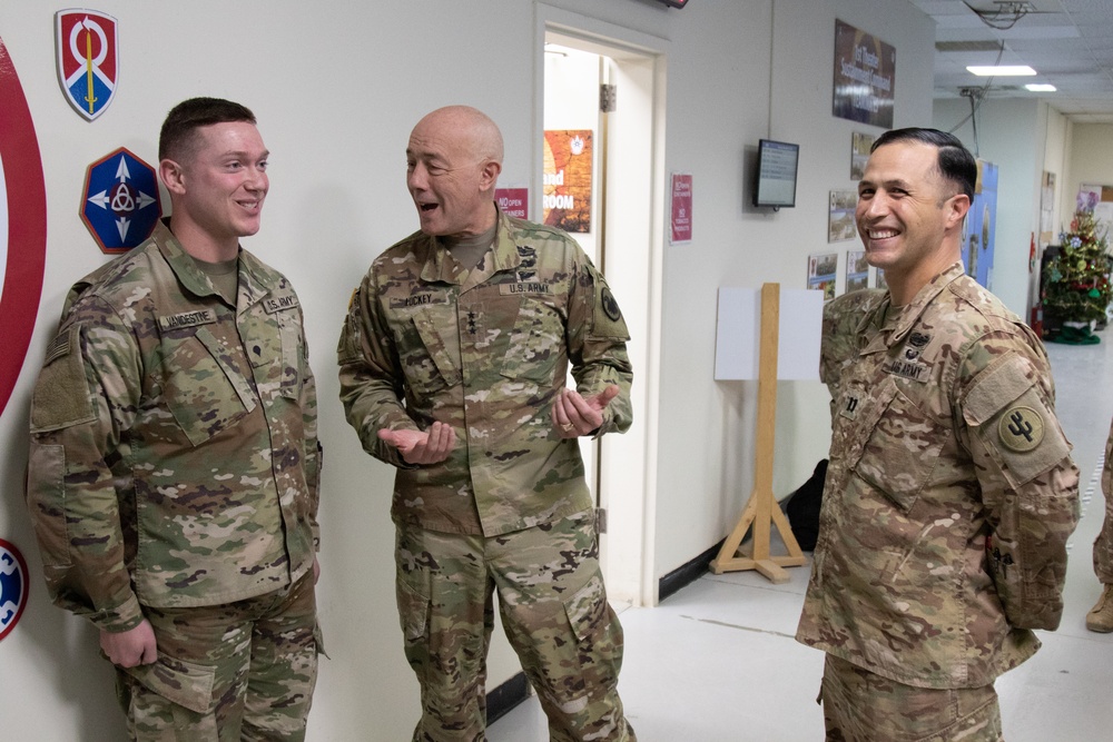 Lt. Gen. Charles D. Luckey presents Spc. Dakota Vanidestine with a challenge coin