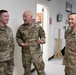 Lt. Gen. Charles D. Luckey presents Spc. Dakota Vanidestine with a challenge coin