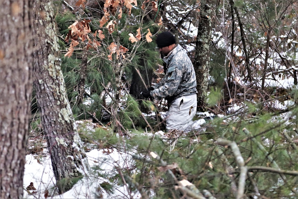 Cold-Weather Operations Course students build improvised shelters, survive outdoors
