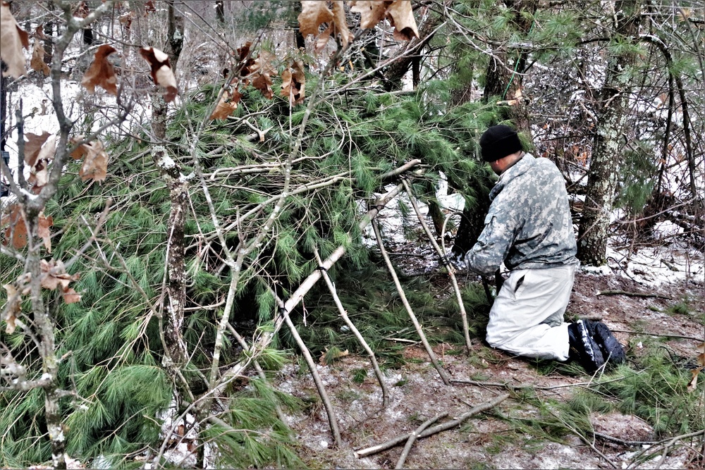 Cold-Weather Operations Course students build improvised shelters, survive outdoors