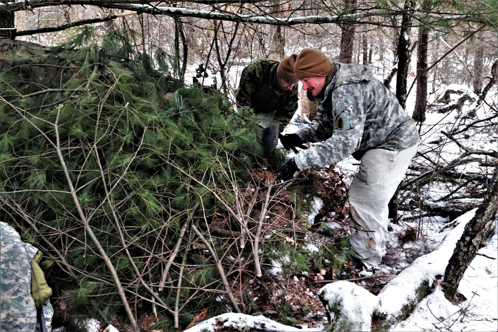 Cold-Weather Operations Course students build improvised shelters, survive outdoors