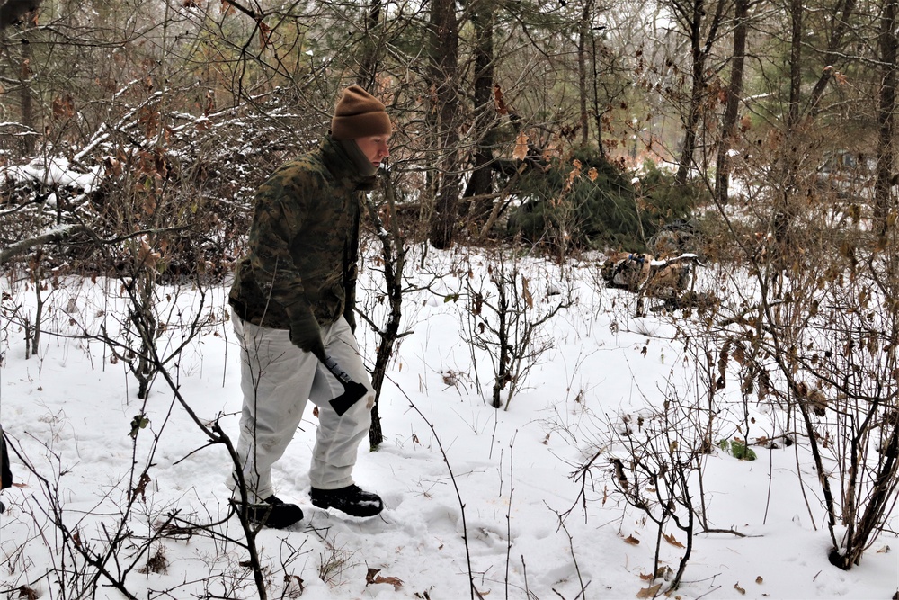 Cold-Weather Operations Course students build improvised shelters, survive outdoors