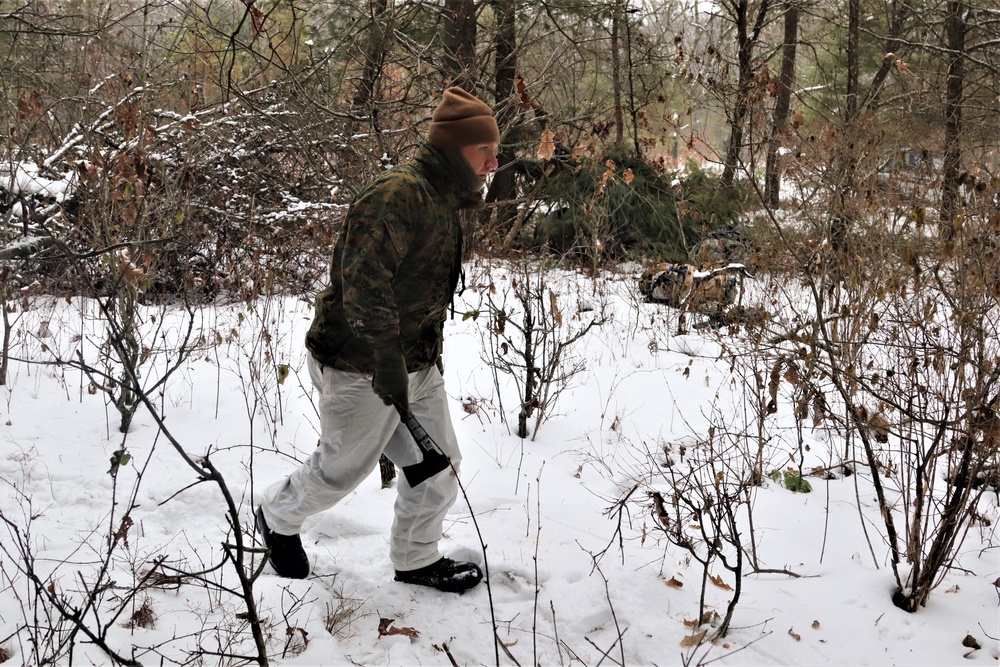 Cold-Weather Operations Course students build improvised shelters, survive outdoors