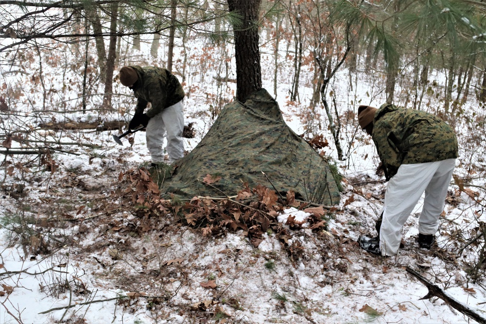 Cold-Weather Operations Course students build improvised shelters, survive outdoors