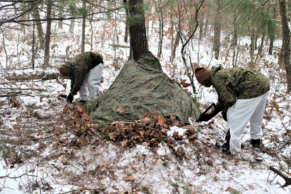 Cold-Weather Operations Course students build improvised shelters, survive outdoors