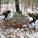 Cold-Weather Operations Course students build improvised shelters, survive outdoors