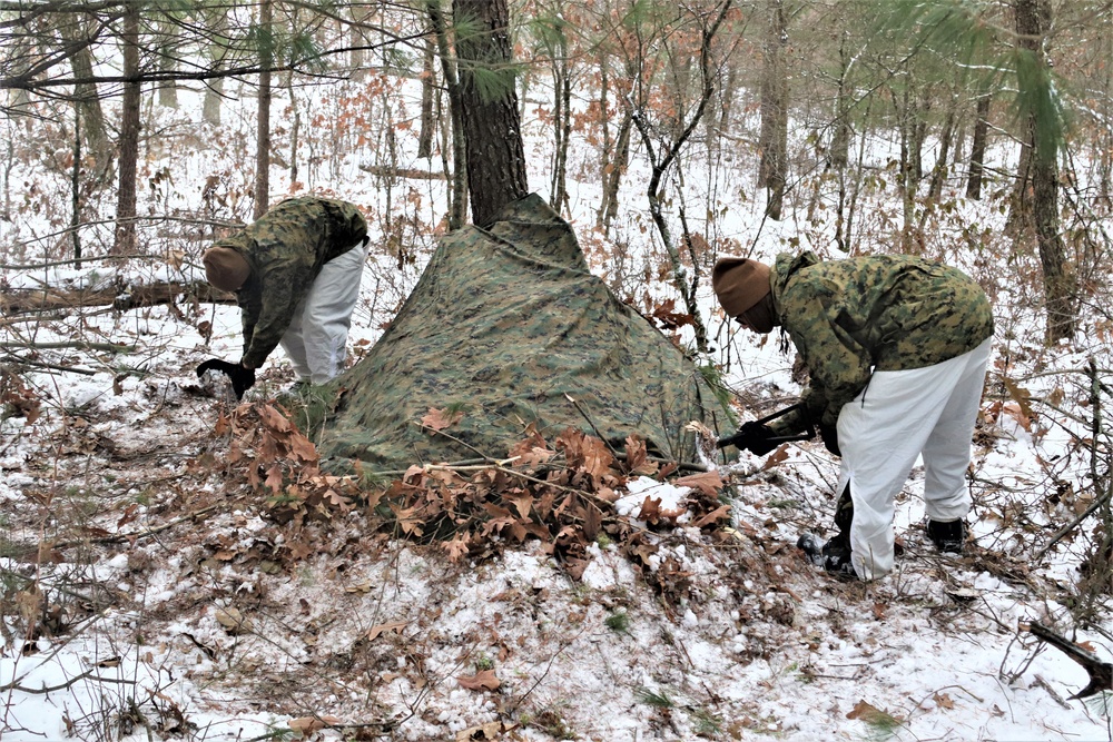 Cold-Weather Operations Course students build improvised shelters, survive outdoors