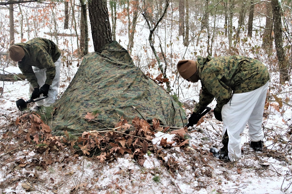 Cold-Weather Operations Course students build improvised shelters, survive outdoors