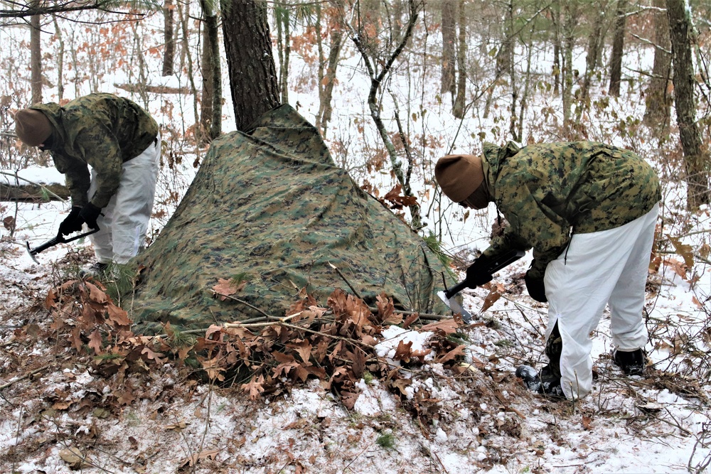 Cold-Weather Operations Course students build improvised shelters, survive outdoors