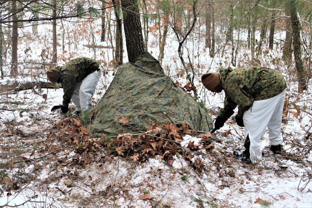 Cold-Weather Operations Course students build improvised shelters, survive outdoors