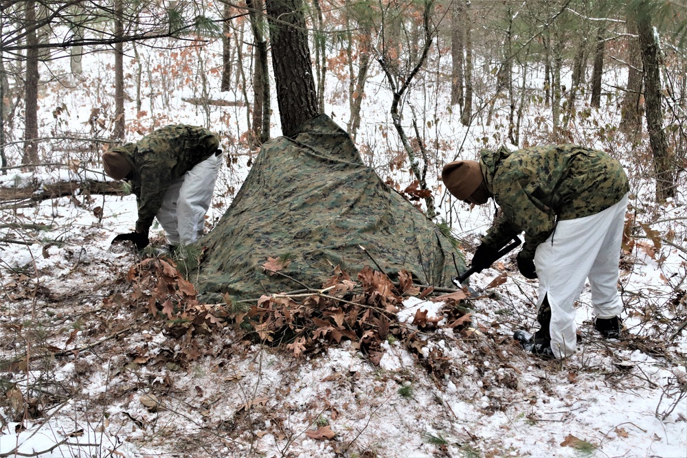 Cold-Weather Operations Course students build improvised shelters, survive outdoors