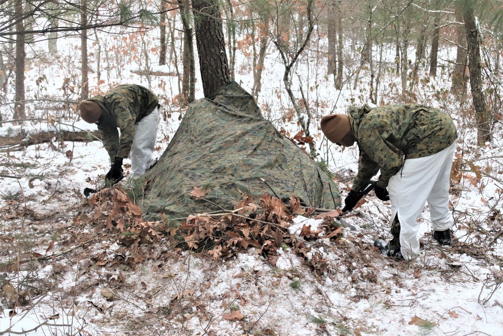 Cold-Weather Operations Course students build improvised shelters, survive outdoors