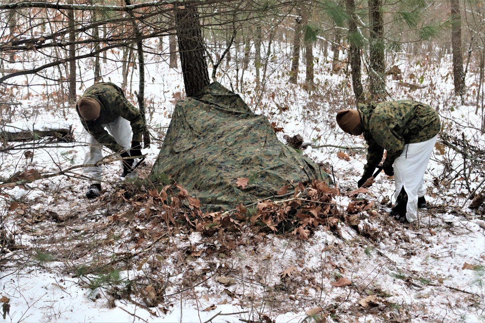 Cold-Weather Operations Course students build improvised shelters, survive outdoors