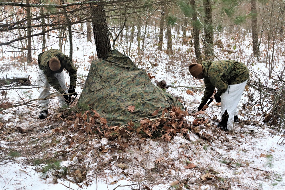 Cold-Weather Operations Course students build improvised shelters, survive outdoors