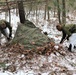 Cold-Weather Operations Course students build improvised shelters, survive outdoors