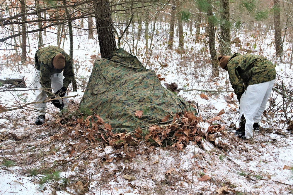 Cold-Weather Operations Course students build improvised shelters, survive outdoors