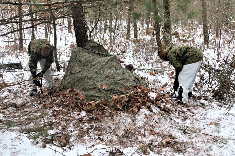 Cold-Weather Operations Course students build improvised shelters, survive outdoors