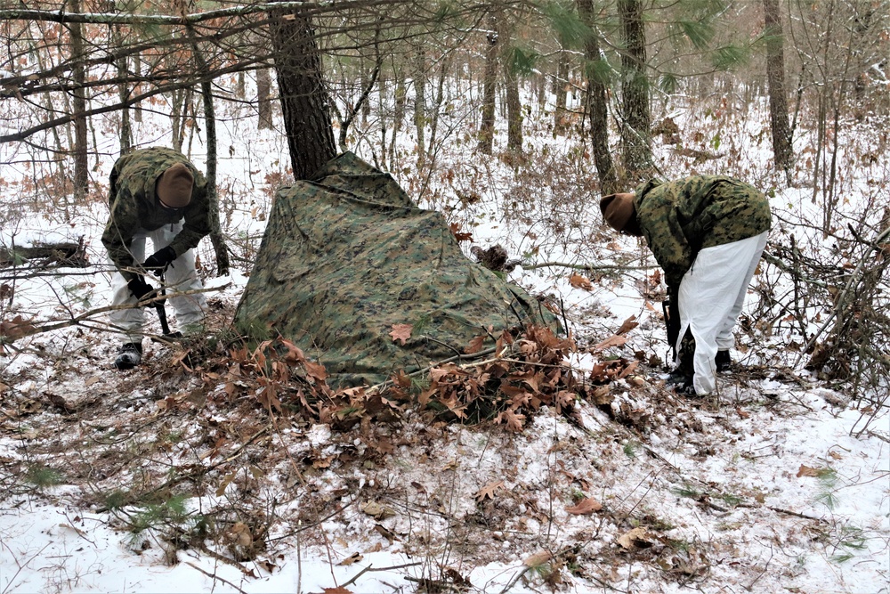 Cold-Weather Operations Course students build improvised shelters, survive outdoors