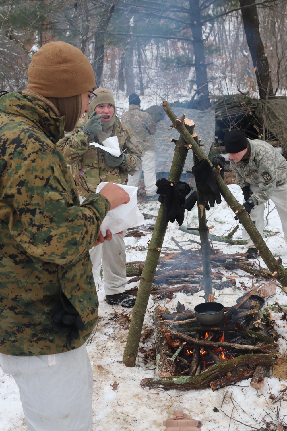 Cold-Weather Operations Course students build improvised shelters, survive outdoors