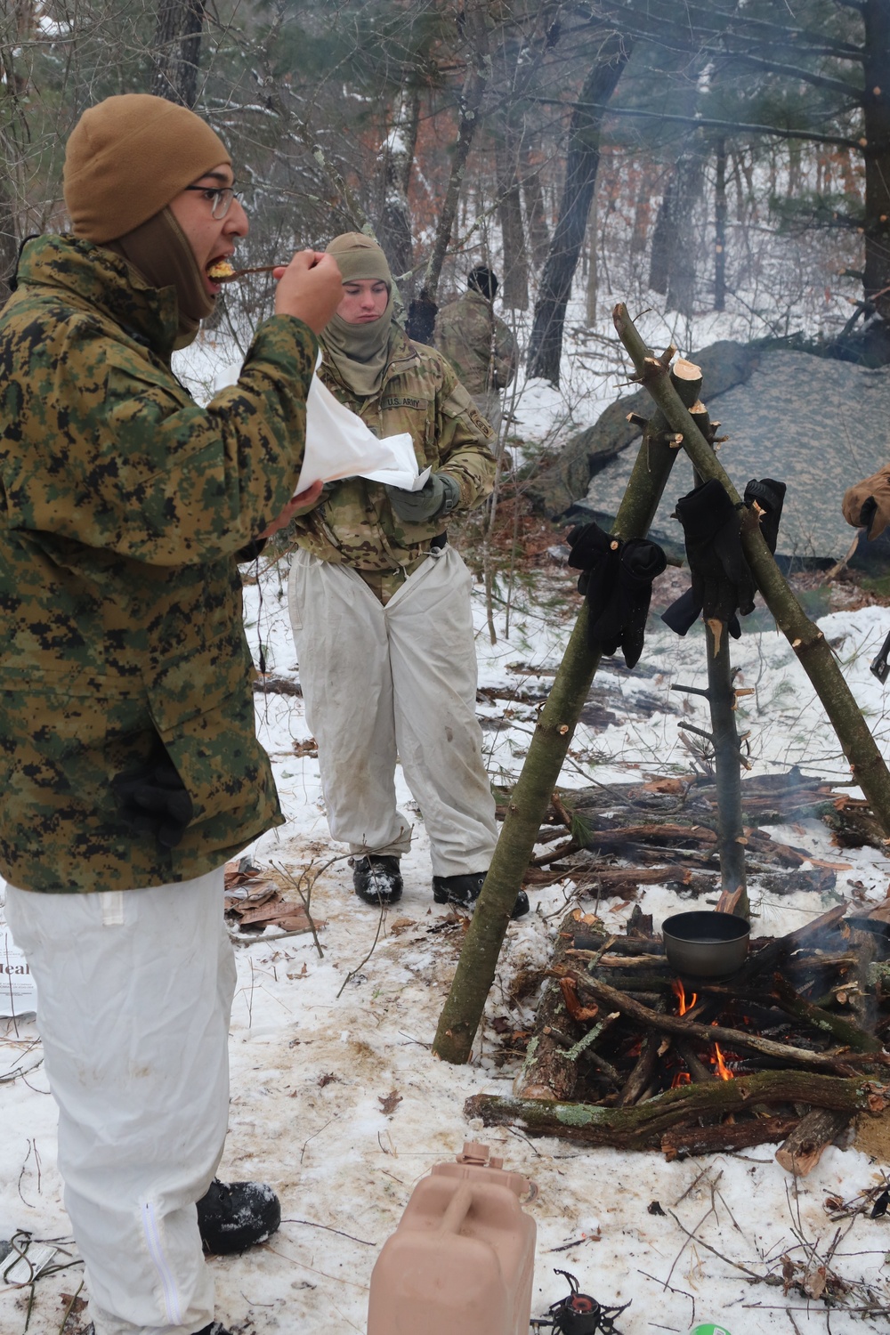 Cold-Weather Operations Course students build improvised shelters, survive outdoors