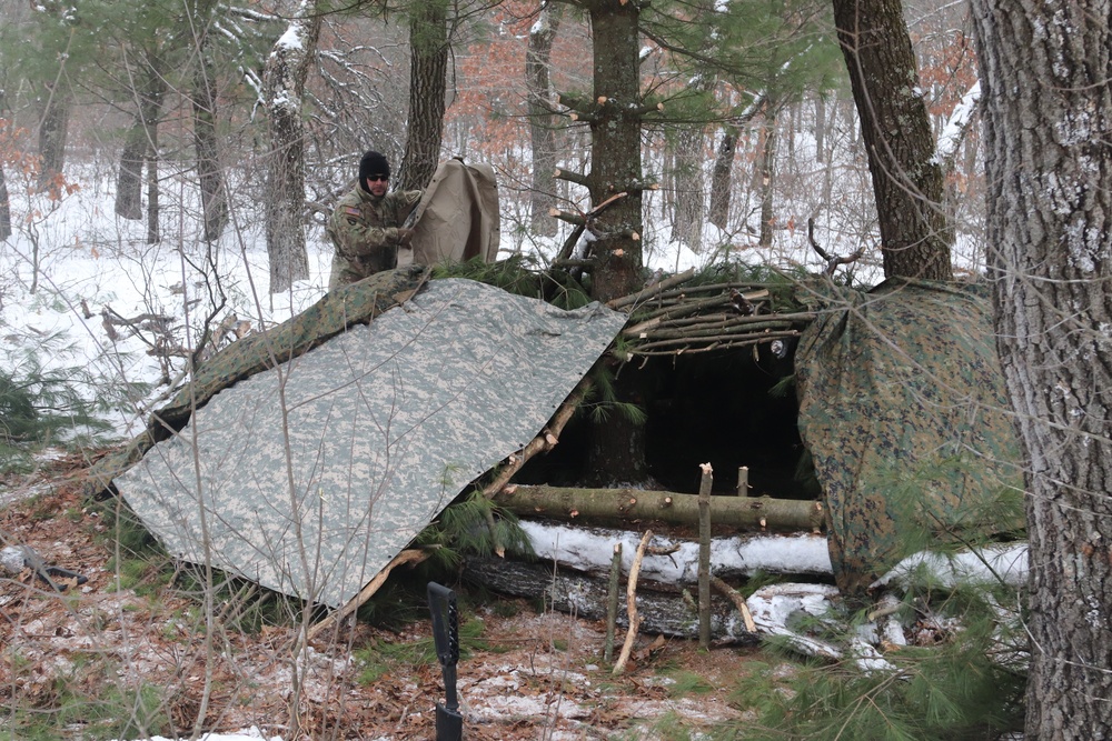 Cold-Weather Operations Course students build improvised shelters, survive outdoors