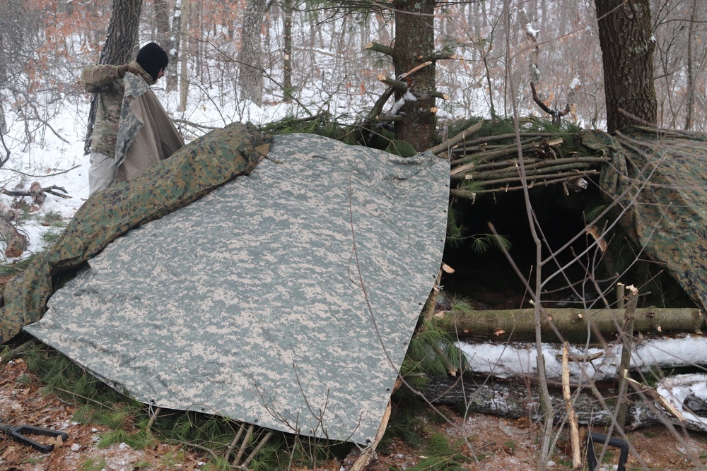 Cold-Weather Operations Course students build improvised shelters, survive outdoors