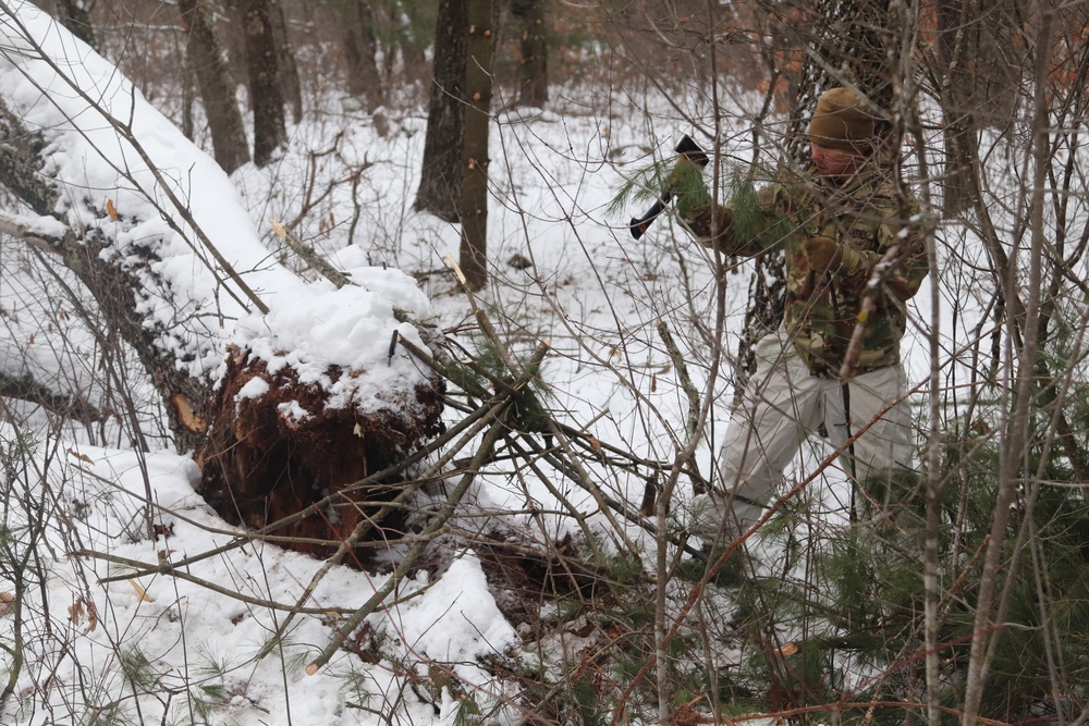 Cold-Weather Operations Course students build improvised shelters, survive outdoors