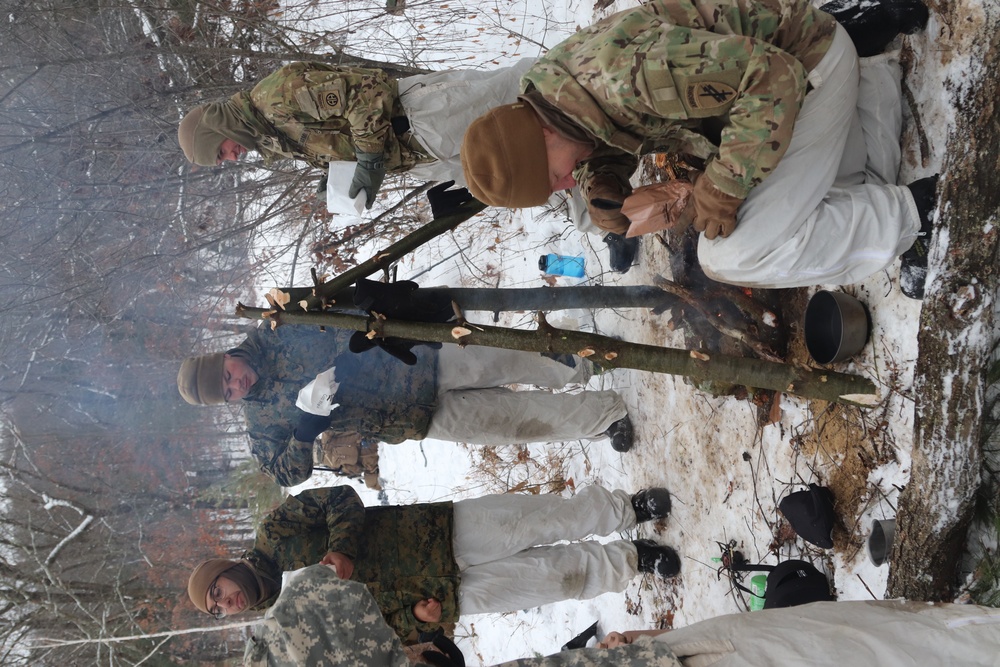 Cold-Weather Operations Course students build improvised shelters, survive outdoors