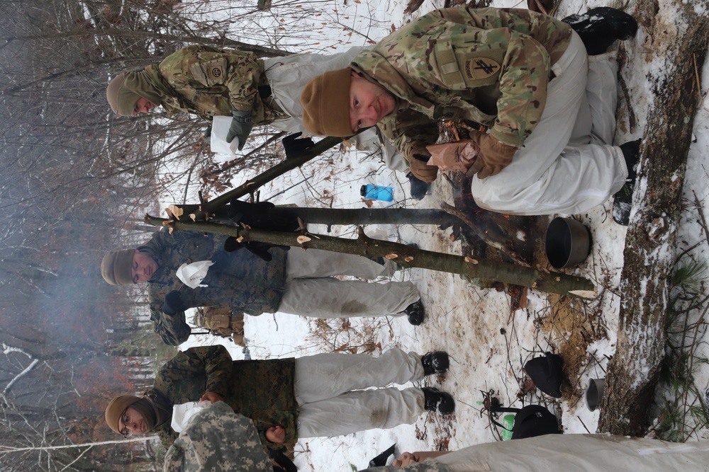 Cold-Weather Operations Course students build improvised shelters, survive outdoors