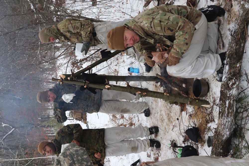 Cold-Weather Operations Course students build improvised shelters, survive outdoors