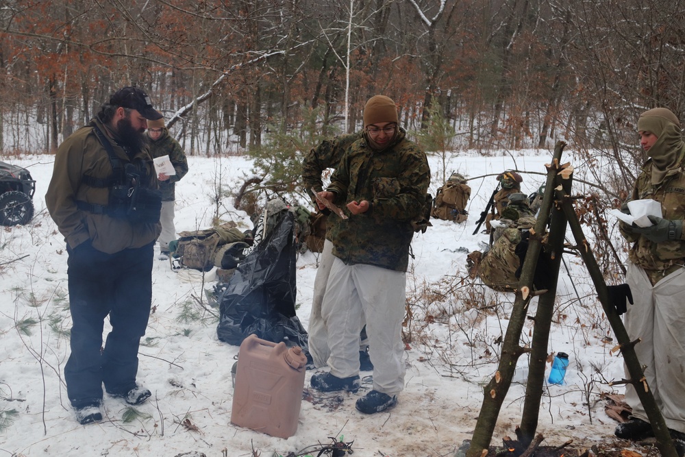 Cold-Weather Operations Course students build improvised shelters, survive outdoors