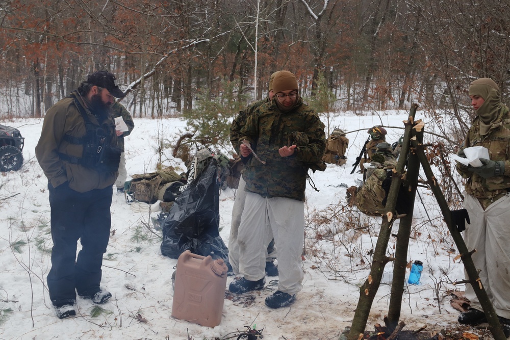 Cold-Weather Operations Course students build improvised shelters, survive outdoors