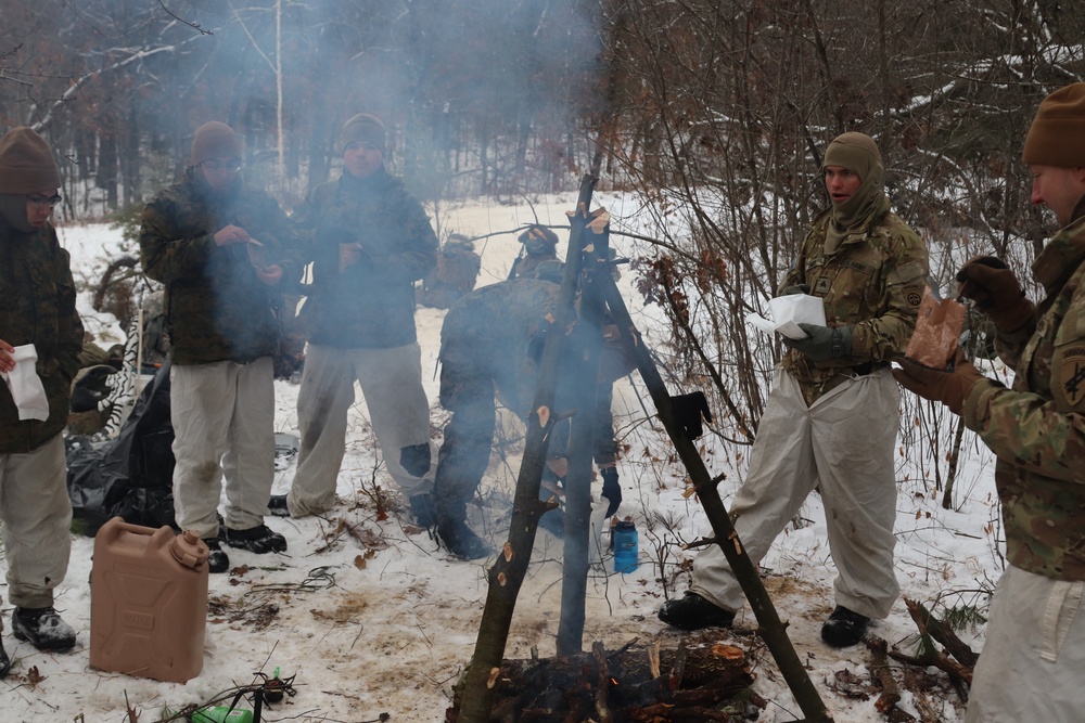 Cold-Weather Operations Course students build improvised shelters, survive outdoors