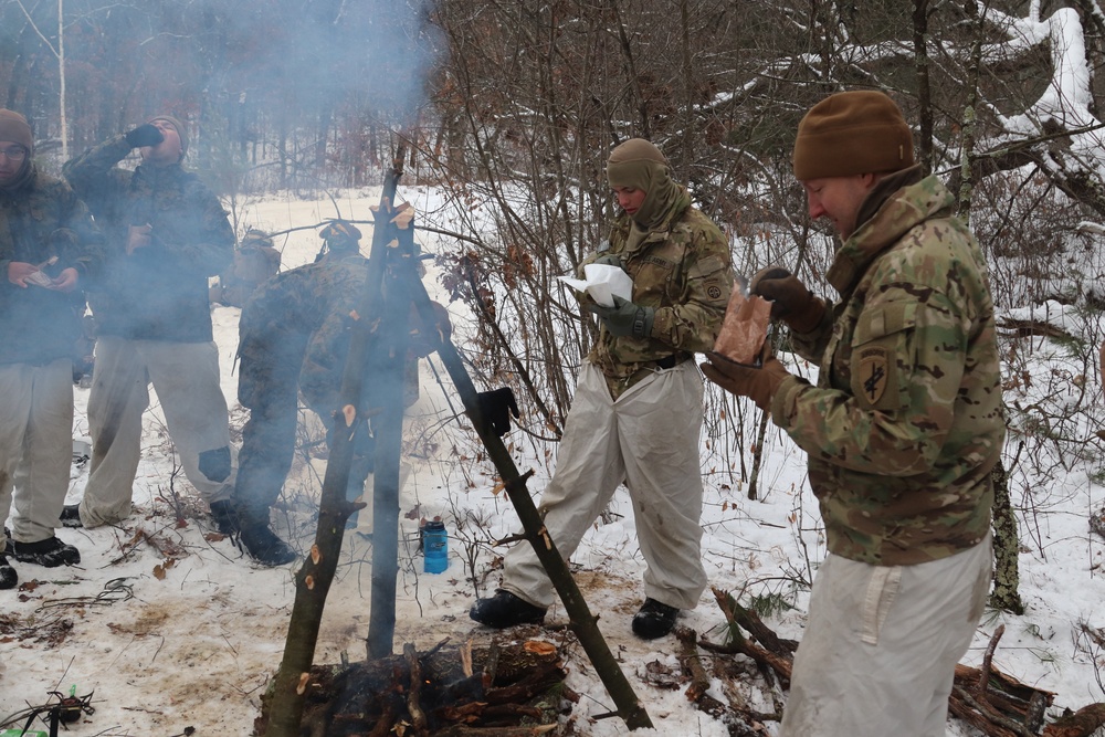 Cold-Weather Operations Course students build improvised shelters, survive outdoors