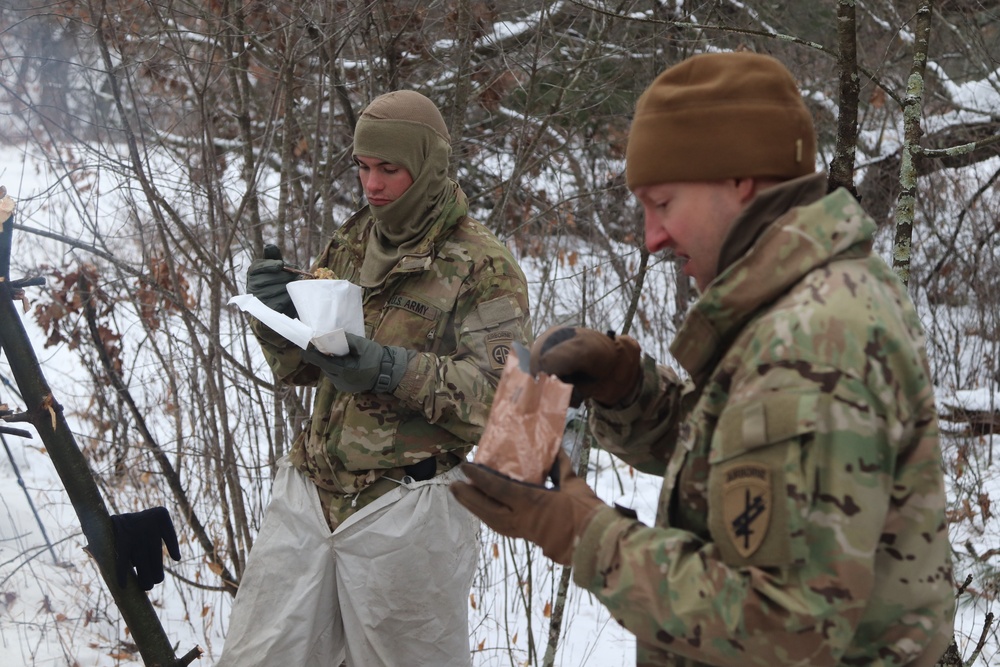 Cold-Weather Operations Course students build improvised shelters, survive outdoors