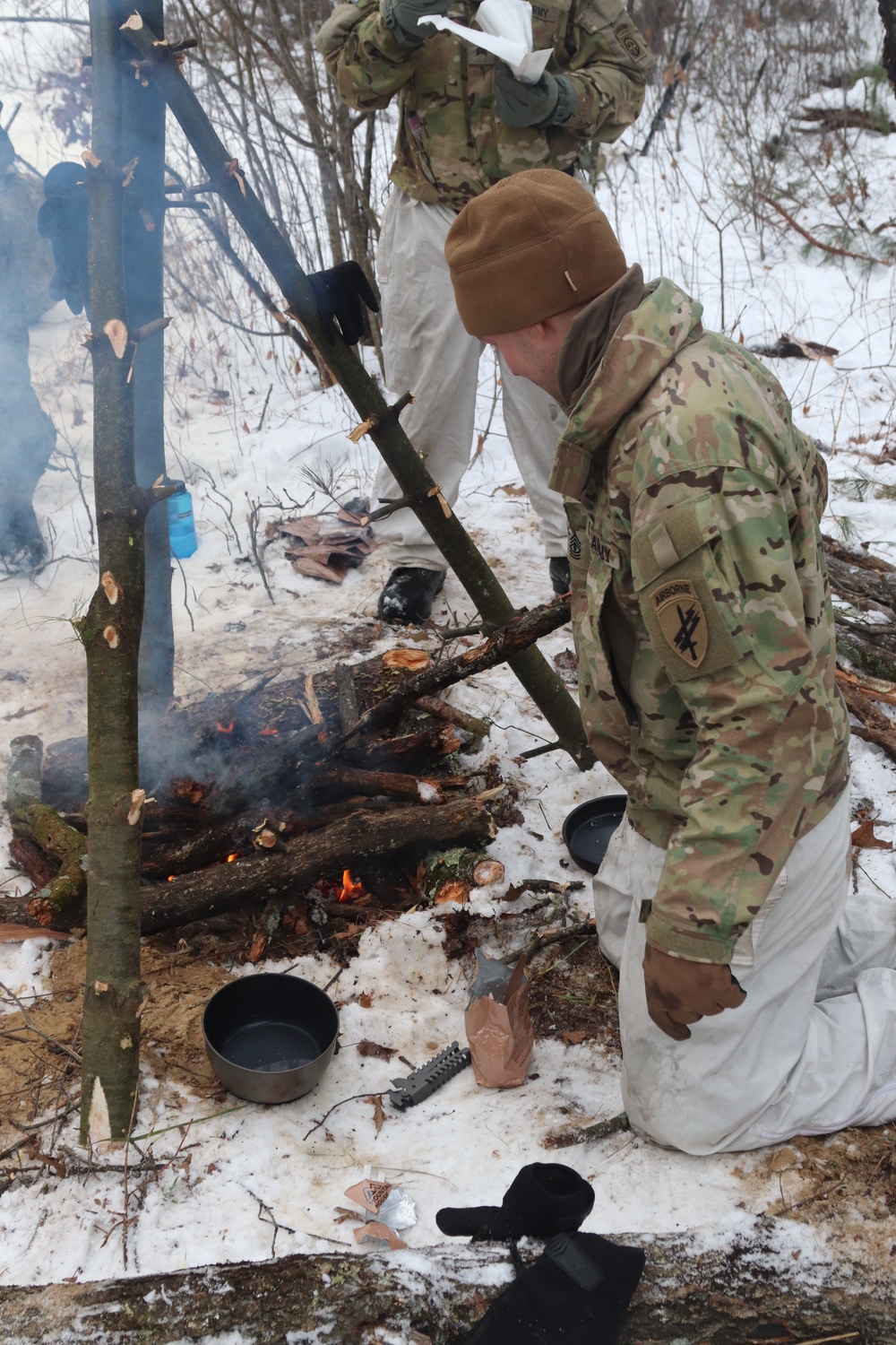 Cold-Weather Operations Course students build improvised shelters, survive outdoors