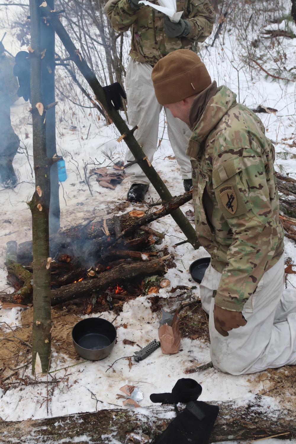 Cold-Weather Operations Course students build improvised shelters, survive outdoors