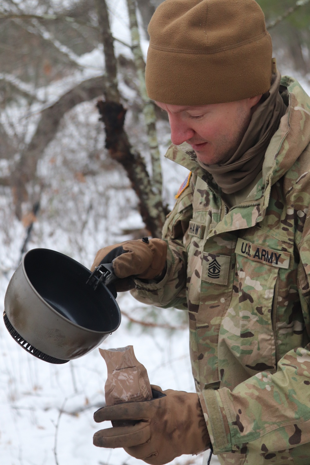 Cold-Weather Operations Course students build improvised shelters, survive outdoors