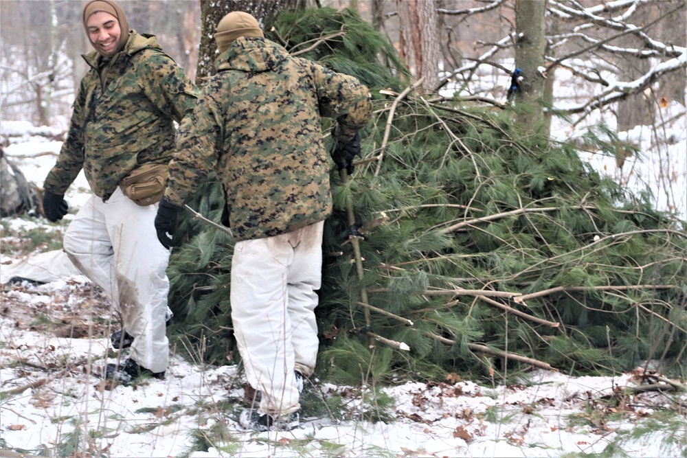 Cold-Weather Operations Course students build improvised shelters, survive outdoors