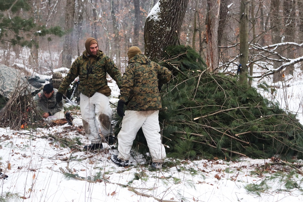 Cold-Weather Operations Course students build improvised shelters, survive outdoors