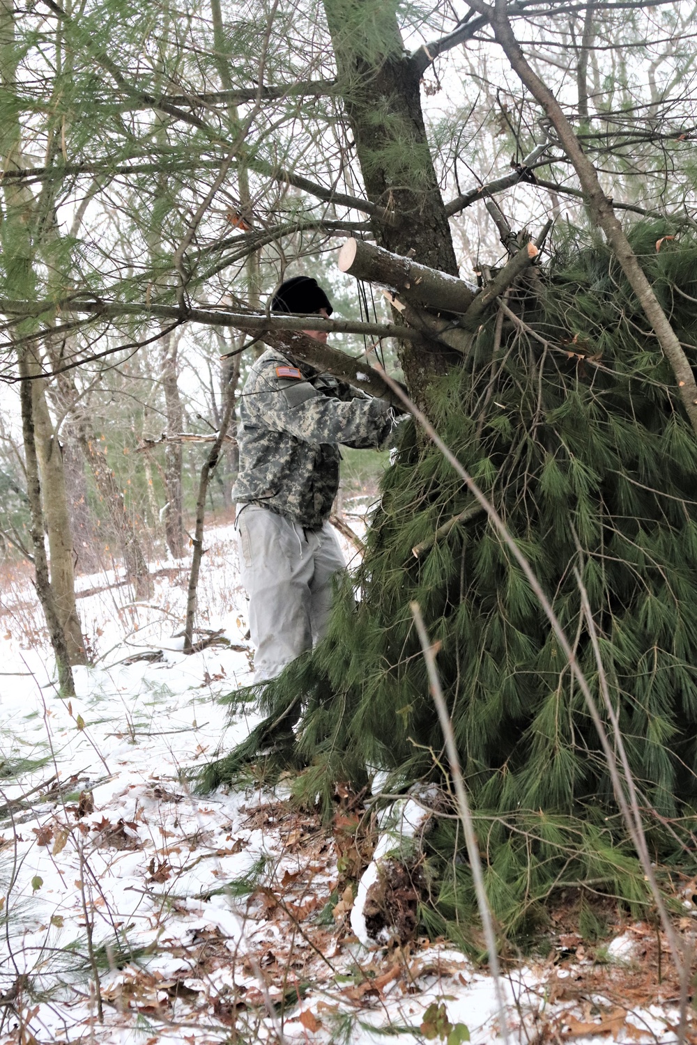 Cold-Weather Operations Course students build improvised shelters, survive outdoors