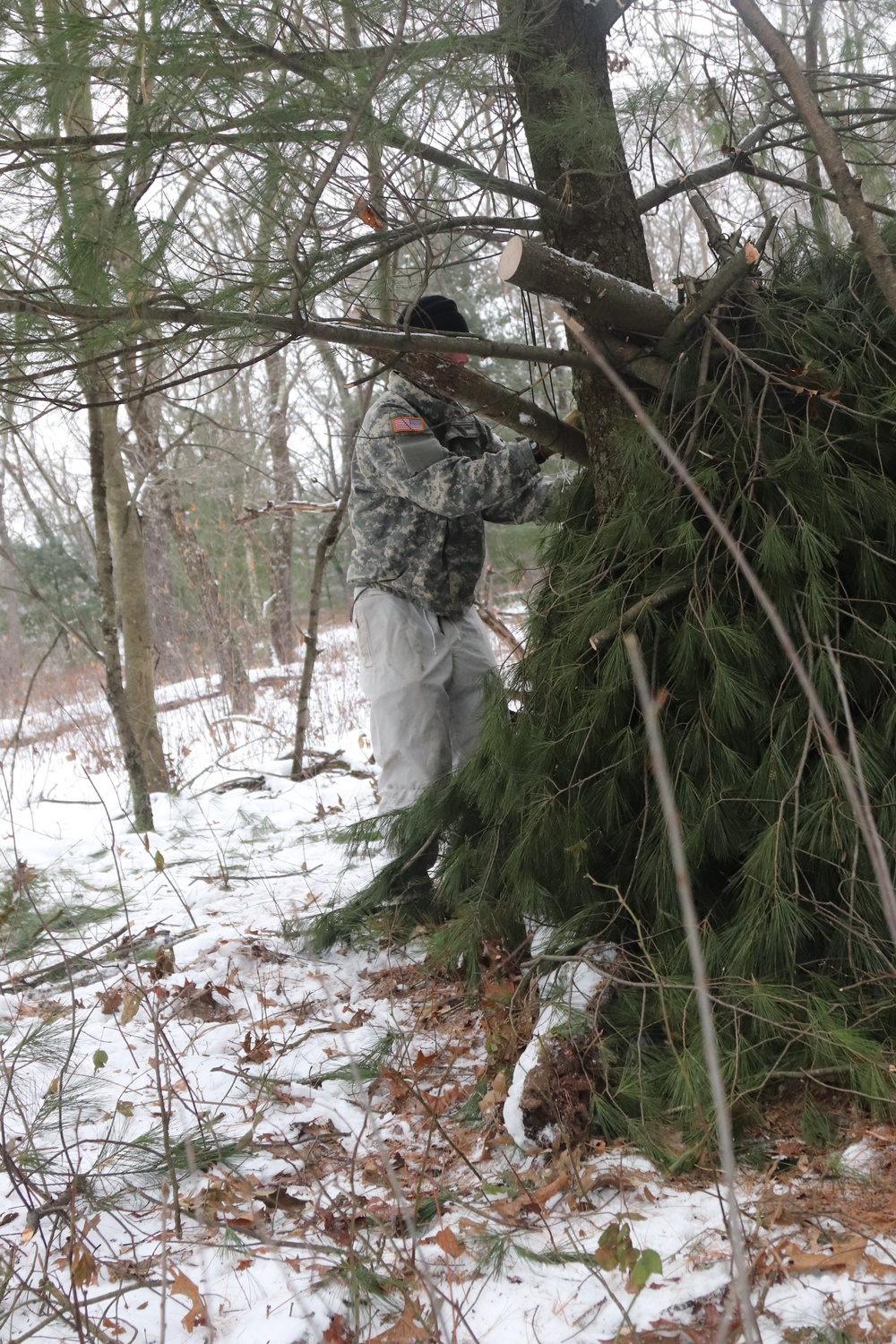 Cold-Weather Operations Course students build improvised shelters, survive outdoors