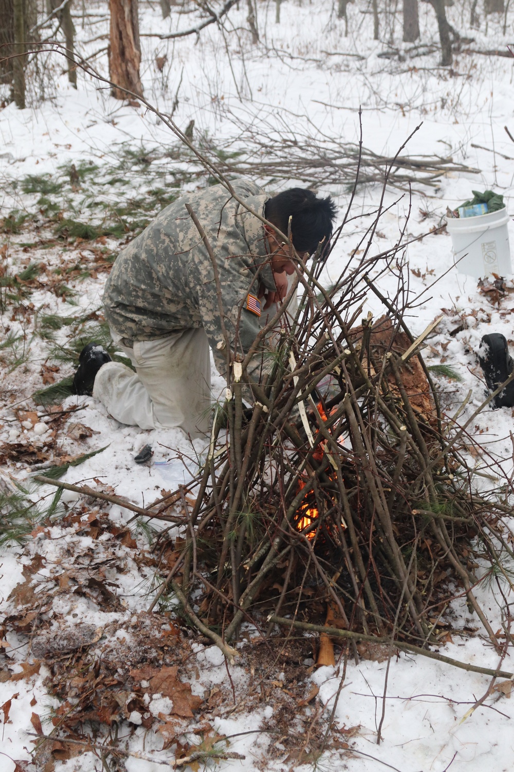 Cold-Weather Operations Course students build improvised shelters, survive outdoors