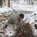 Cold-Weather Operations Course students build improvised shelters, survive outdoors