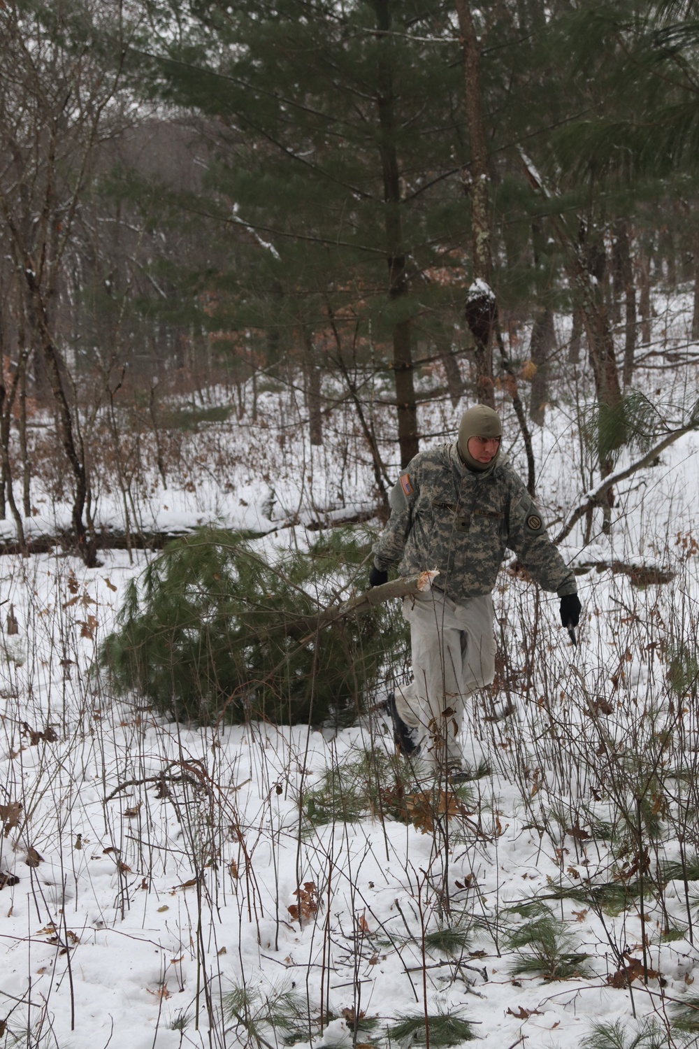 Cold-Weather Operations Course students build improvised shelters, survive outdoors