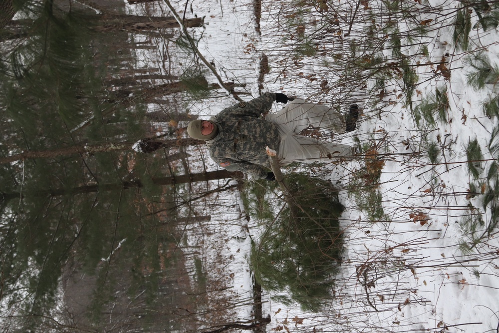 Cold-Weather Operations Course students build improvised shelters, survive outdoors