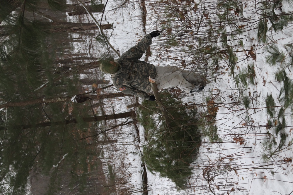 Cold-Weather Operations Course students build improvised shelters, survive outdoors