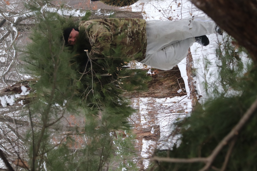 Cold-Weather Operations Course students build improvised shelters, survive outdoors