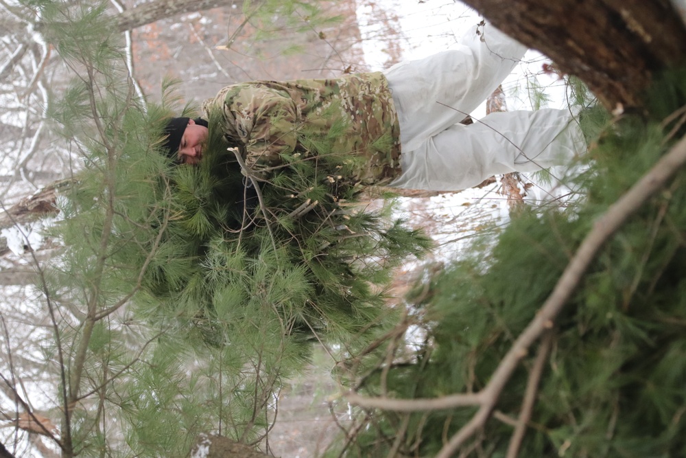 Cold-Weather Operations Course students build improvised shelters, survive outdoors