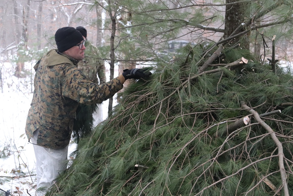 Cold-Weather Operations Course students build improvised shelters, survive outdoors